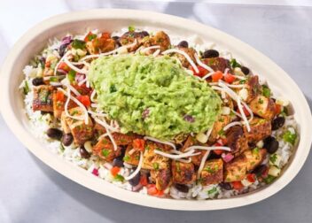 Chipotle burrito bowl with guacamole — official brand food photograph