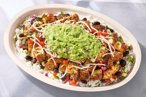 Chipotle burrito bowl with guacamole — official brand food photograph