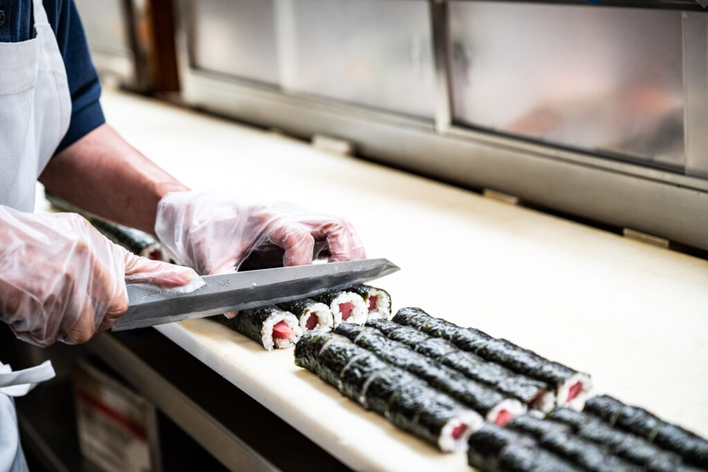 Sushi preparation at One World Market in Novi